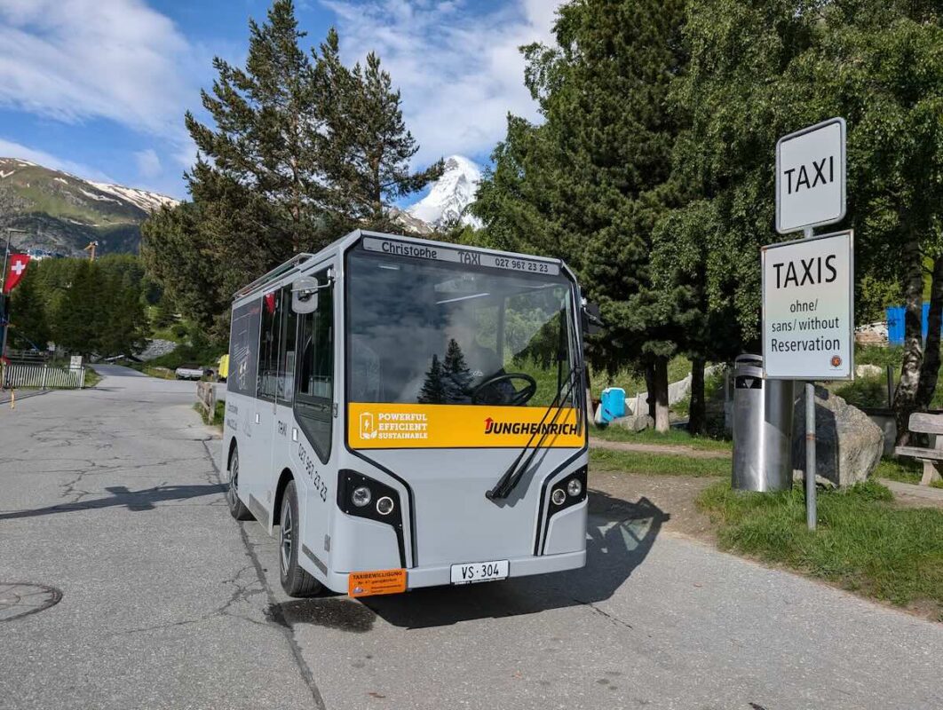 An electric taxi in Switzerland's famous Zermatt ski area with the Matterhorn behind it. Zermatt is one of the most sustainable mountain resorts in the world, having banned all gas-powered vehicles.