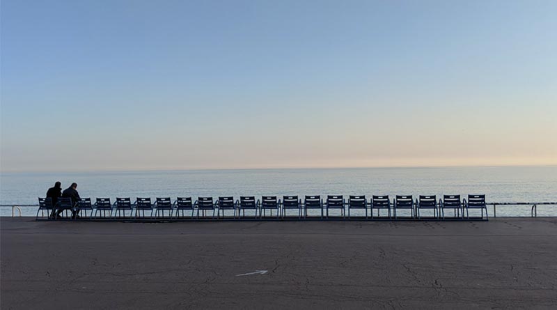 A couple sits on the beach during the coronavirus lockdown in Nice